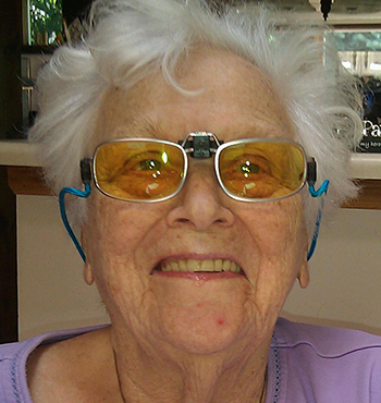 Patient reading a book with magnifier